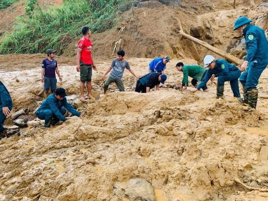 Soldiers and villagers dig through mud after a landslide swamps a village in Phuoc Loc district, Quang Nam province, Vietnam on Thursday, Oct. 29, 2020. Three separated landslides triggered by typhoon Molave killed over a dozen villagers and left dozens more missing in the province as rescuers scramble to recover more victims.
