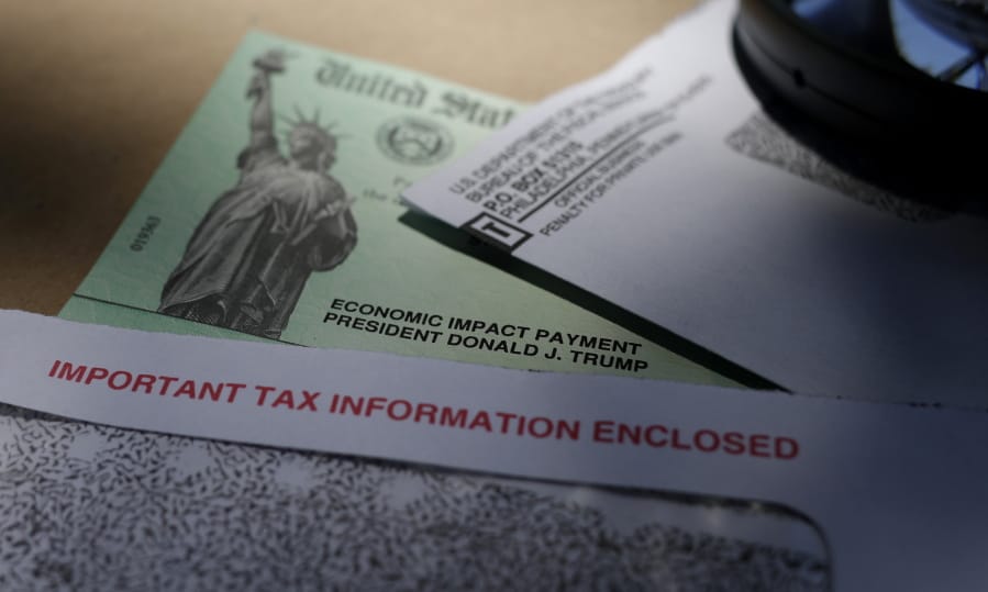 FILE - In this April 23, 2020, file photo, President Donald Trump&#039;s name is seen on a stimulus check issued by the IRS to help combat the adverse economic effects of the COVID-19 outbreak, in San Antonio. All that aid is now gone.