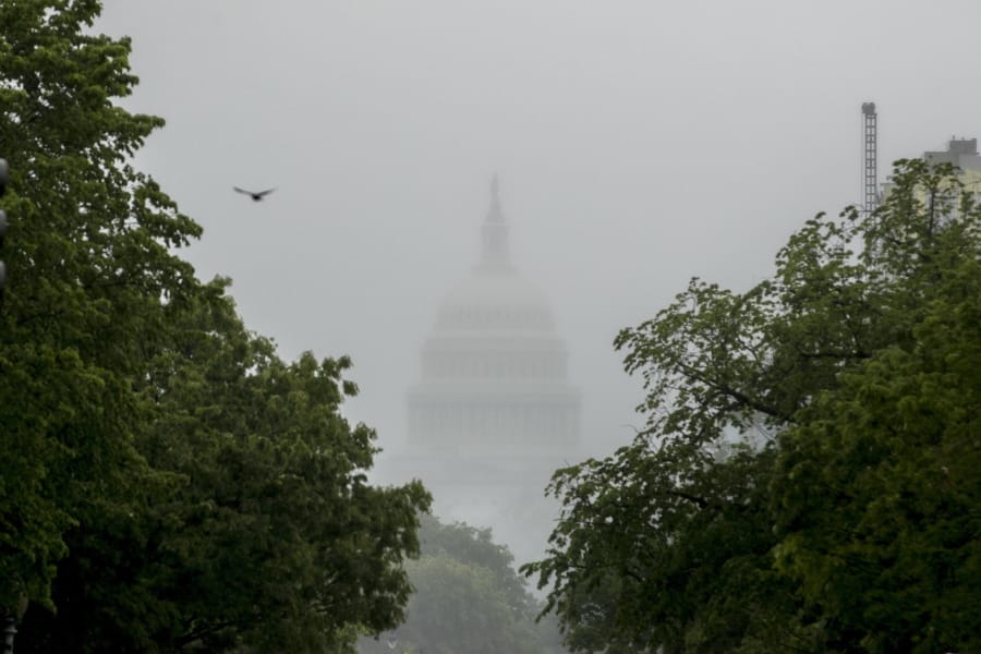 FILE - In this May 22, 2020, file photo the Dome of the U.S. Capitol Building is visible through heavy fog in Washington. New virus relief will have to wait until after the November election. Congress is past the point at which it can deliver more coronavirus aid soon, with differences between House Speaker Nancy Pelosi, Senate Republicans and President Donald Trump proving insurmountable.