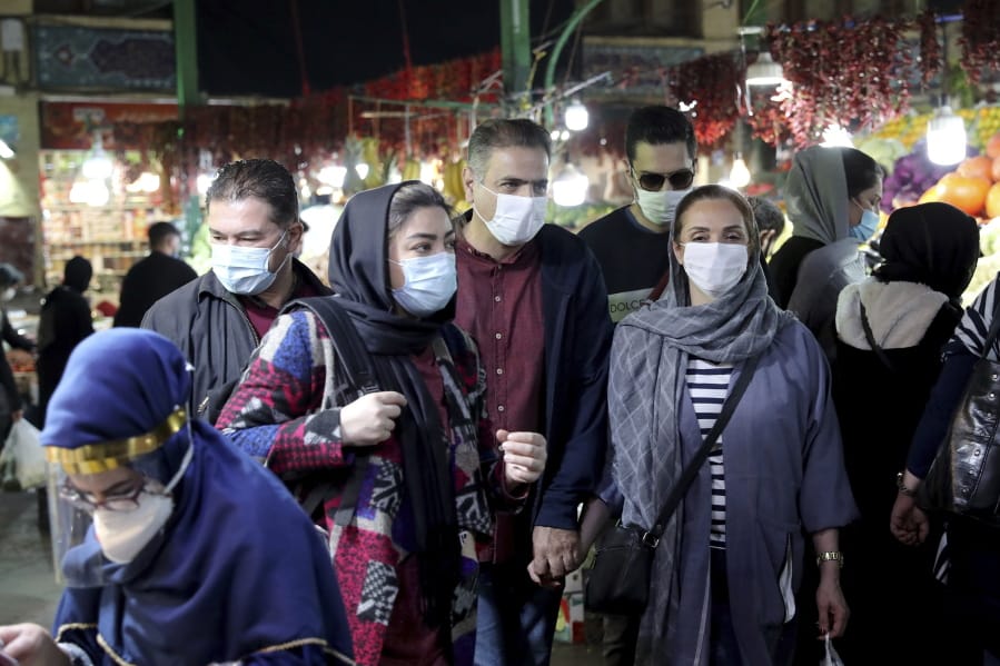 In this Oct. 15, 2020 file photo, people wear protective face masks to help prevent the spread of the coronavirus, in the Tajrish traditional bazaar in northern Tehran, Iran. On Monday, Oct.19, 2020, Iran recorded its worst day of new deaths since the start of the coronavirus pandemic, with 337 confirmed dead.