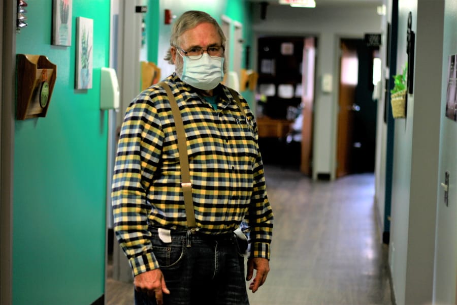 Dr. Tom Dean stands in his clinic Friday in Wessington Springs, S.D. He is one of three doctors in the county, which has seen a surge in virus cases.