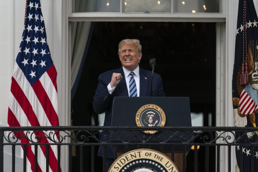 President Donald Trump speaks from the Blue Room Balcony of the White House to a crowd of supporters, Saturday, Oct. 10, 2020, in Washington.