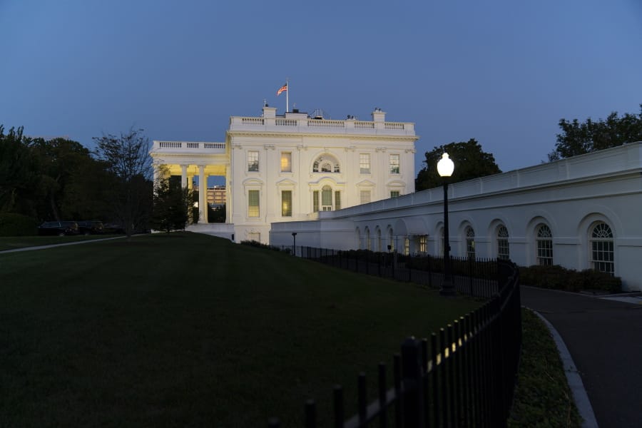 The White House is illuminated at sunset, Tuesday, Oct. 6, 2020, in Washington.
