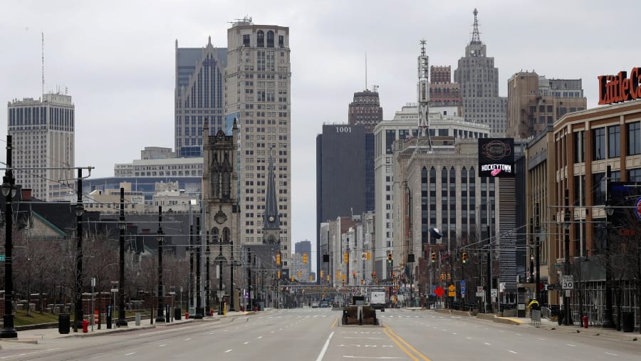 In this March 24, 2020 file photo, Woodward Avenue is shown nearly empty in Detroit. Before the coronavirus showed up, downtown Detroit was returning to its roots as a vibrant city center, motoring away from its past as the model of urban ruin. Now, with the coronavirus forcing many office workers to their homes in the suburbs, those who remain wonder if revitalization will ever return.