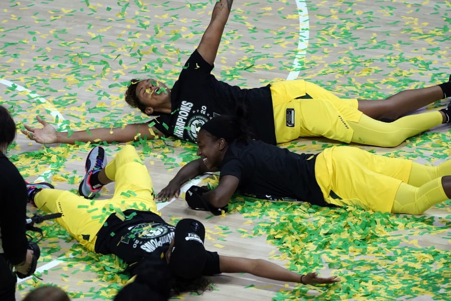 Seattle Storm players, including Mercedes Russell, top, play in the confetti after the team won the WNBA Finals Tuesday  in Bradenton, Fla. The Storm swept the Las Vegas Aces in the best-of-five series.