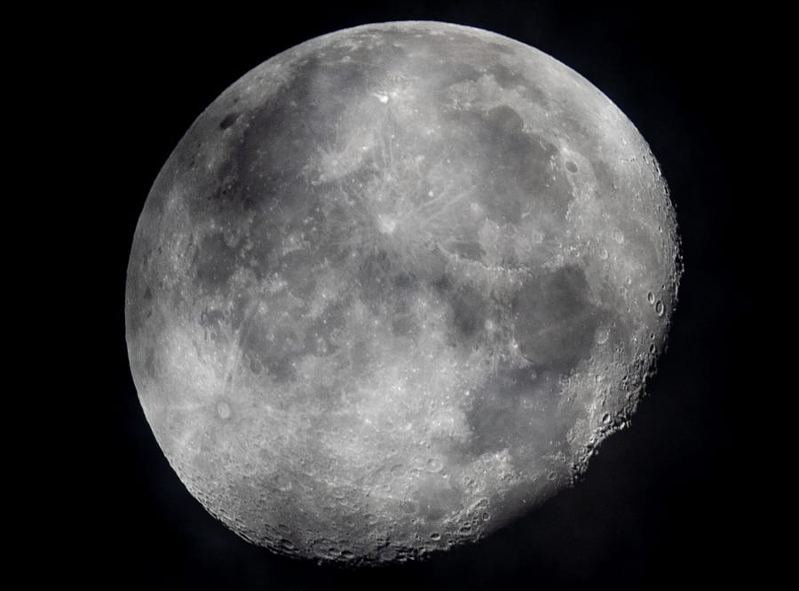 FILE - In this early Monday, Oct. 5, 2020, file photo, a waning moon is seen at the sky over Frankfurt, Germany. The moon&#039;s shadowed, frigid nooks and crannies may hold frozen water in more places and in larger quantities than previously suspected, good news for astronauts at future lunar bases who could tap into these resources for drinking and making rocket fuel, scientists reported Monday, Oct. 26, 2020.