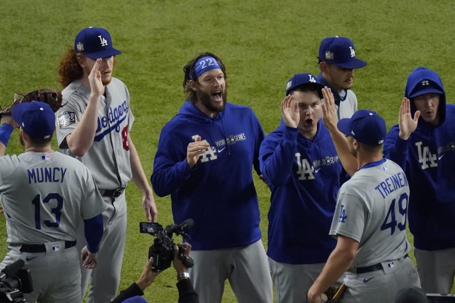 Los Angeles Dodgers starting pitcher Clayton Kershaw, center, celebrates after their 4-2 win against the Tampa Bay Rays in Game 5 of the World Series on Sunday.