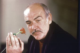FILE - In this Jan. 23, 1987 file photo, actor Sean Connery holds a rose in his hand as he talks about his new movie "The Name of the Rose" at a news conference in London.  Scottish actor Sean Connery, considered by many to have been the best James Bond, has died aged 90, according to an announcement from his family.