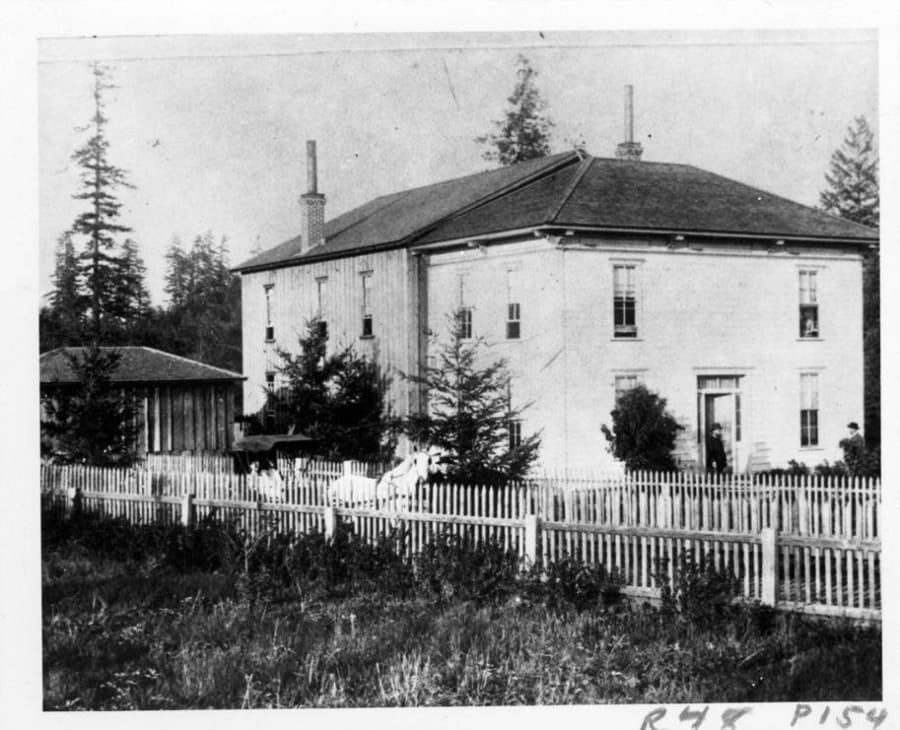 This 1892 photo may be of the first building for the Washington School for Defective Youth and matches the description as part farmhouse in reports. By 1892, the Legislature funded a second, more suitable brick building. Despite its odious name, concerns for the disabled reach back into Washington&#039;s territorial days. Several early attempts failed. Then in 1886, the territorial legislature approved funding for a state school to educate the disabled and located it in Vancouver. The photo places the school at Fourth Plain (then a general locality, not a street) and Burnt Bridge Creek.