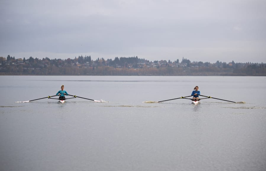 Rowers Kate Feustel, left, and Lauren Coop pause for a portrait at Vancouver Lake on Tuesday morning, Nov. 10, 2020.