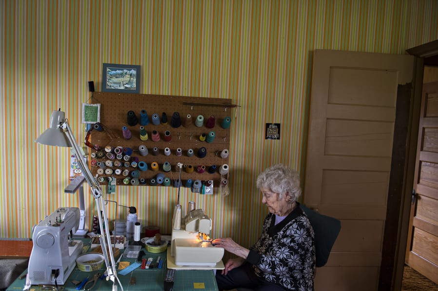 Nina Borroz, 98, has a stack of 40 quilts awaiting donation to veterans groups in the sewing room of her Minnehaha home.