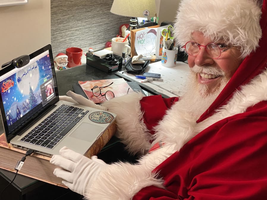 Santa Claus (aka Chuck Gill of Philadelphia) poses for a picture at his desk, where&#039;s he&#039;s set up for video calls with children and families. Gill uses a platform called Visit With Santa, which originated in Vancouver a few years ago. The COVID-19 pandemic is expected to cause unprecedented demand this year.