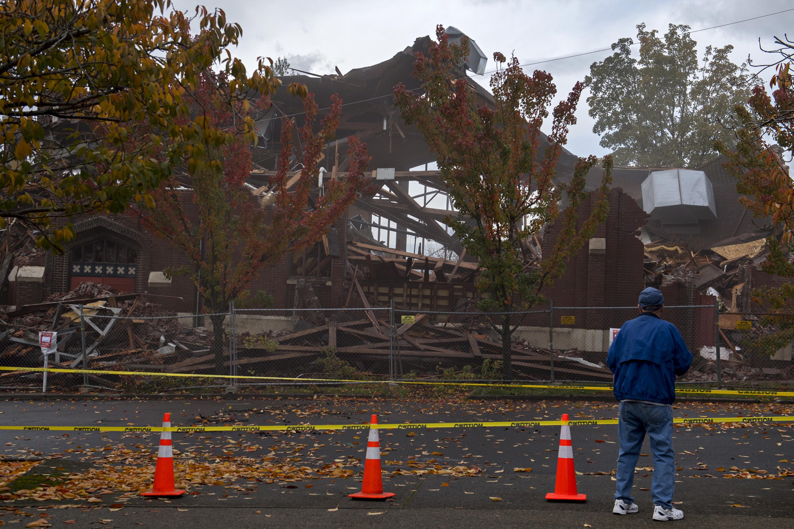 Gary Dunne of Vancouver pauses to take photos during the demolition of the former downtown location of New Heights Church on Friday morning. Dunne was joined by his wife, Marlene, who he married at the church in 1959. The couple raised three daughters there. "It just felt like home," Marlene Dunne said.