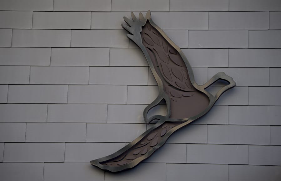 One of five metal eagles takes flight on the side of The Jean building at The Waterfront Vancouver on Monday. Artist Grace Chadwick designed the metal sculptures, five double-layered eagles, in her studio near Fish Hawk Lake, Ore.