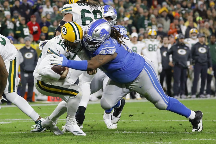 Green Bay quarterback Aaron Rodgers (12) is sacked by Detroit defensive tackle Damon ‘Snacks’ Harrison in a 2019 game. Harrison is set to make his debut with the Seattle Seahawks on Sunday against the Los Angeles Rams.