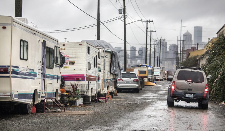 Joe Ingram cruises down an alley in the SODO area of Seattle, where increasing numbers of RV are being parked in 2020.