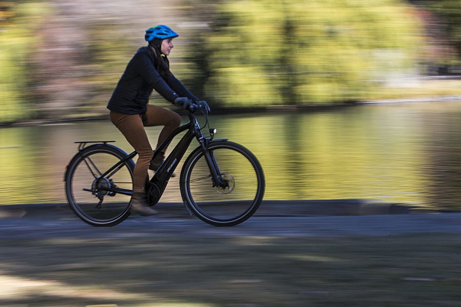 Emma Juth rides an electric bike through Drake Park in Bend, Ore.