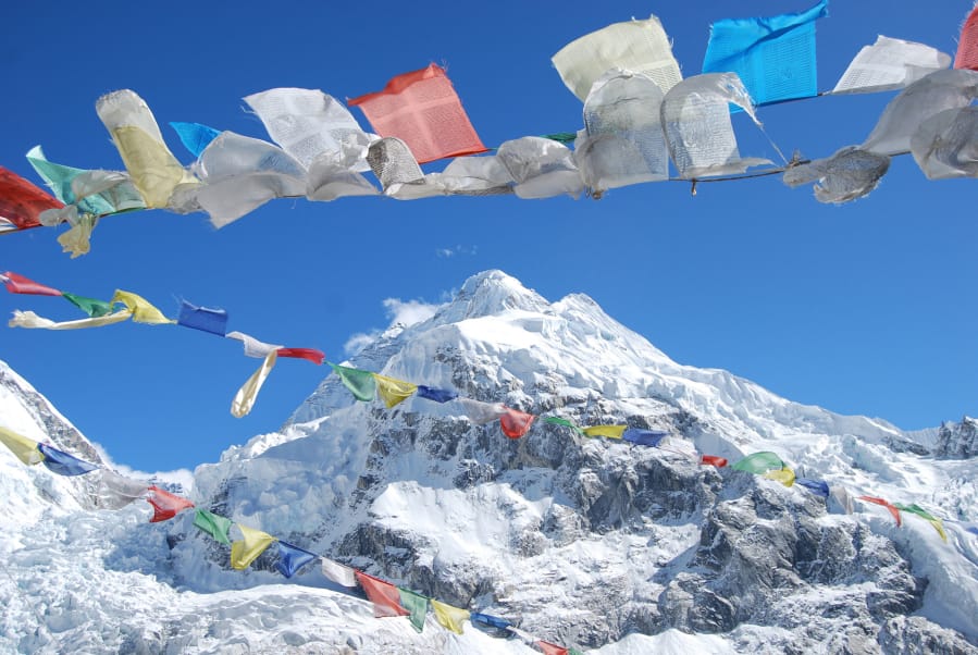 Prayer flags flutter in the breeze at Mount Everest.