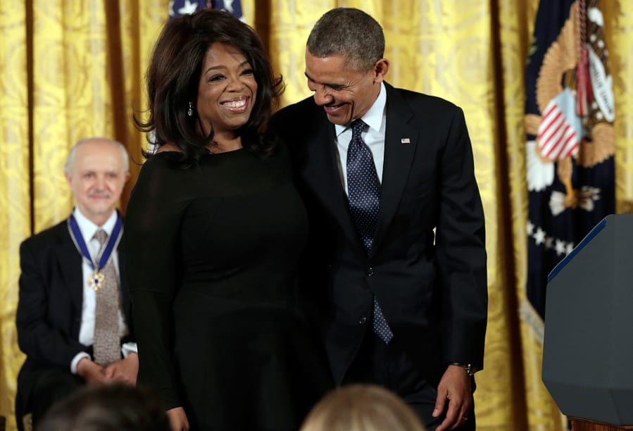 President Barack Obama, right, awards the Presidential Medal of Freedom to Oprah Winfrey in the East Room at the White House on Nov. 20, 2013, in Washington, D.C.