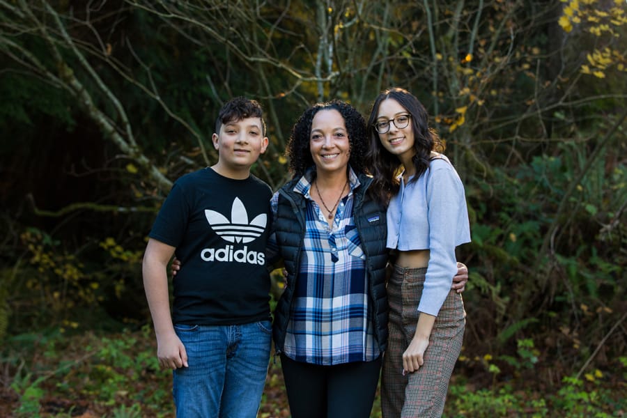 Erinn Baldeschwiler, center, mother of Shea McGinnis, left, and Gibson McGinnis, has been diagnosed with stage 4 metastatic breast cancer. Immunotherapy has helped with the physical symptoms of her illness, dramatically shrinking the size of the tumor on her chest.