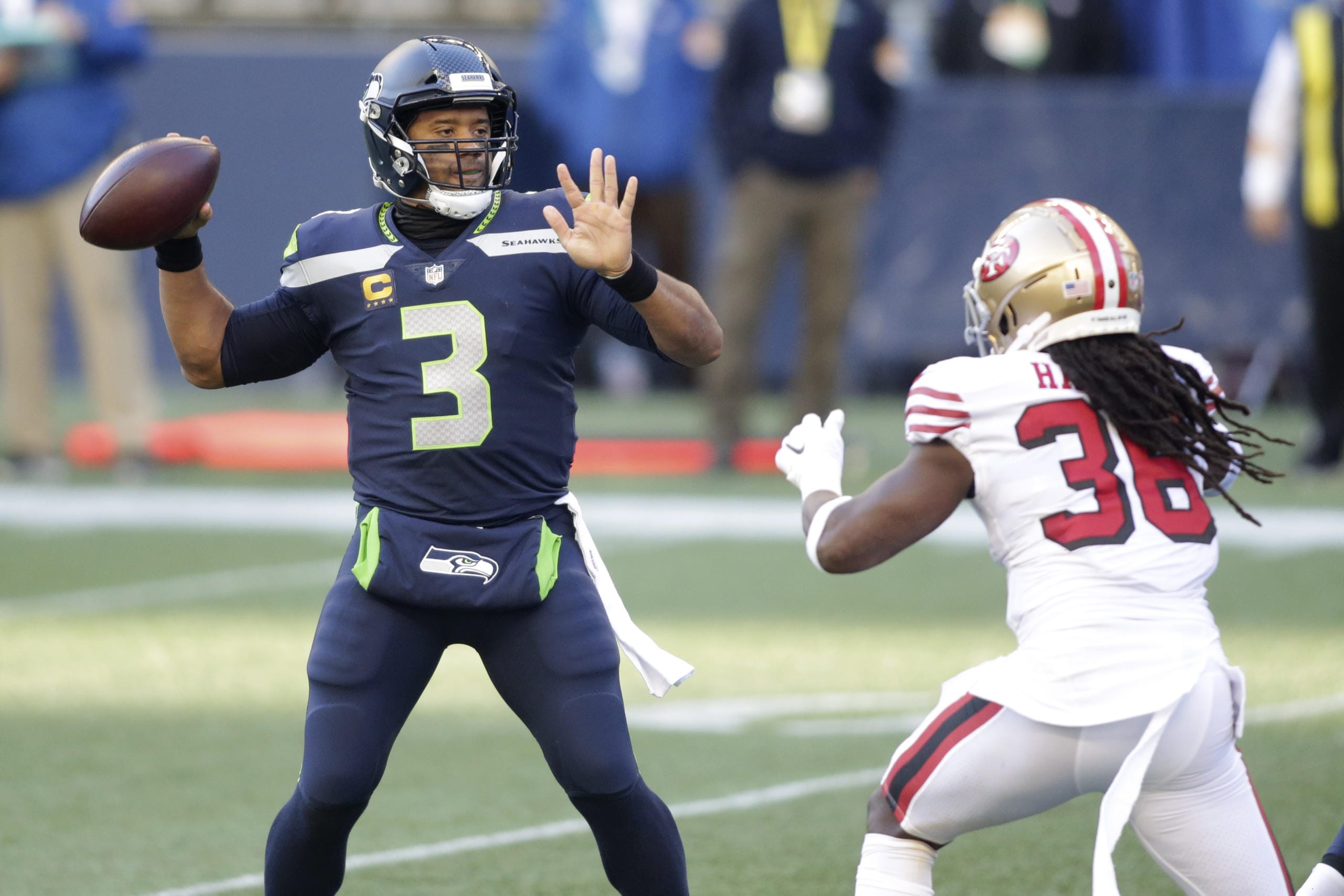 Seattle Seahawks quarterback Russell Wilson (3) makes a touchdown pass to wide receiver DK Metcalf (not shown) as San Francisco 49ers safety Marcell Harris, right, pressures during the first half of an NFL football game, Sunday, Nov. 1, 2020, in Seattle.
