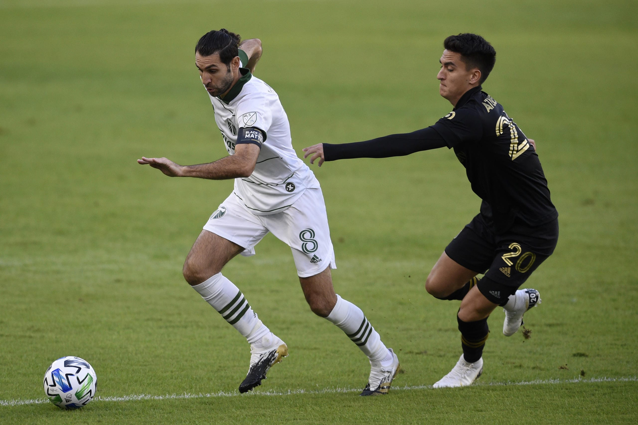 Portland Timbers midfielder Diego Valeri, left, handles the ball while pressured by Los Angeles FC midfielder Eduard Atuesta during the first half of an MLS soccer match in Los Angeles, Sunday, Nov. 8, 2020.