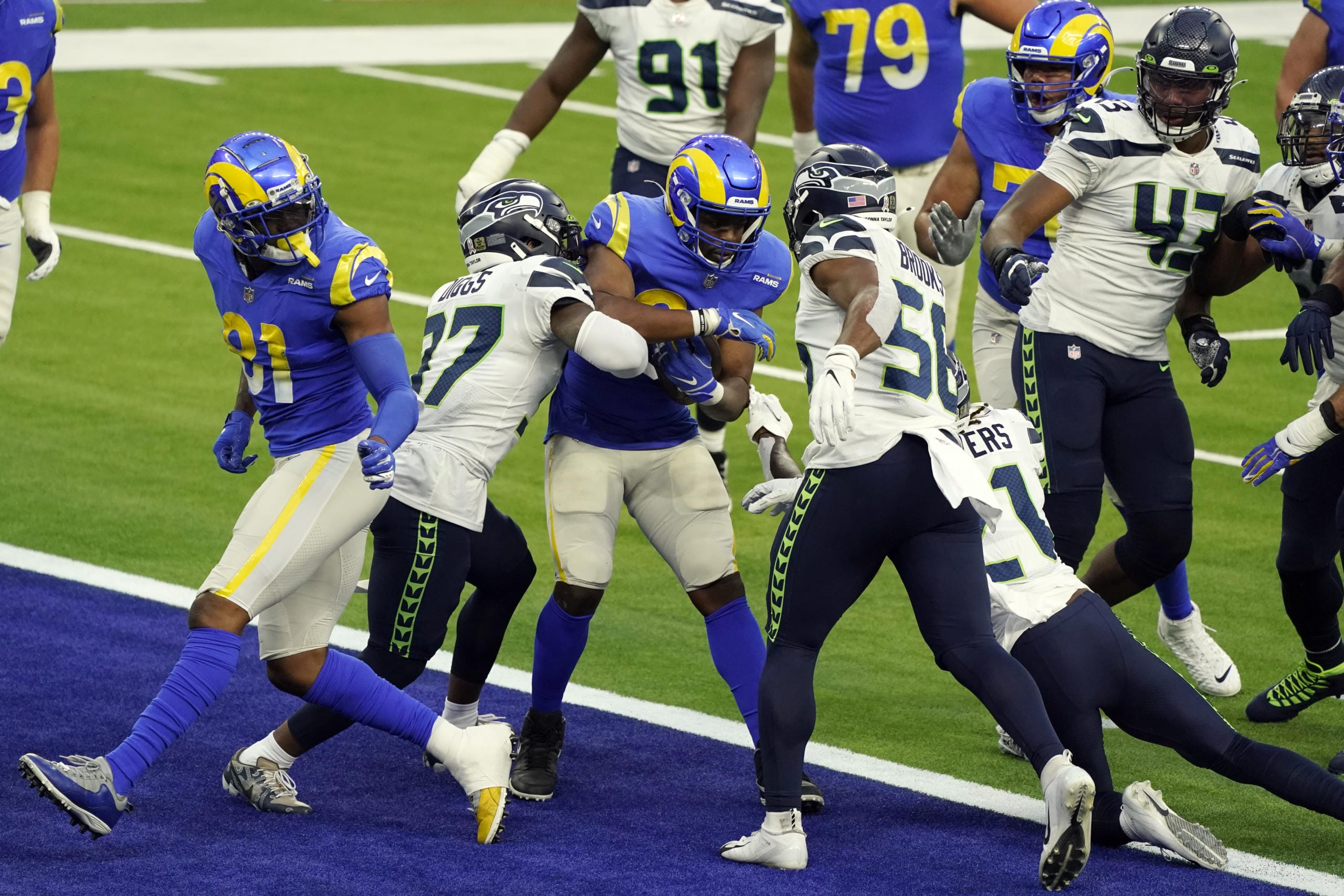 Los Angeles Rams running back Malcolm Brown, center, scores a rushing touchdown against the Seattle Seahawks during the second half of an NFL football game Sunday, Nov. 15, 2020, in Inglewood, Calif.