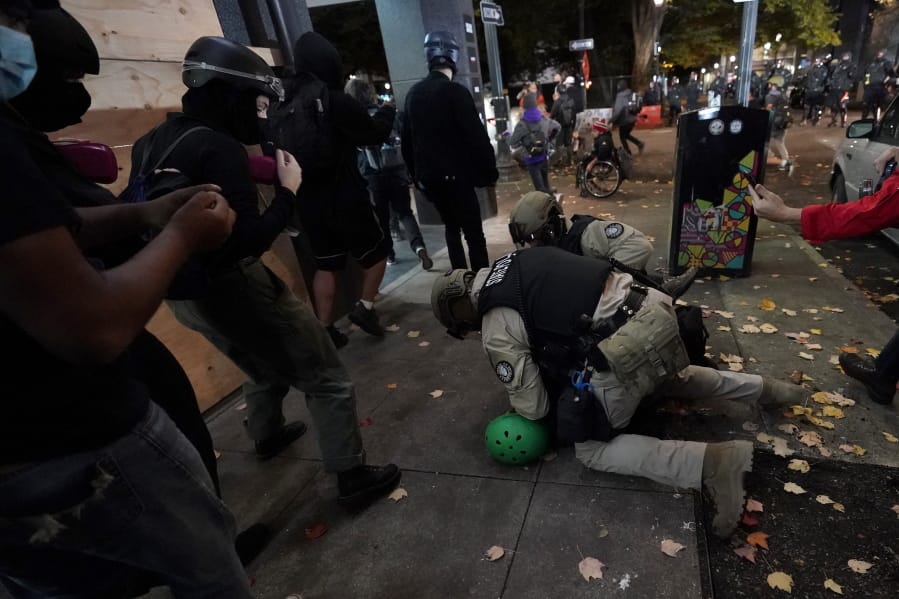 Oregon State Police arrest a protester in Portland, Ore., Wednesday, Nov. 4, 2020, following Tuesday&#039;s election.