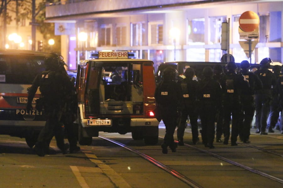 Police officers walk at the scene after gunshots were heard, in Vienna, Monday, Nov. 2, 2020. Austrian police say several people have been injured and officers are out in force following gunfire in the capital Vienna. Initial reports that a synagogue was the target of an attack couldn&#039;t immediately be confirmed.