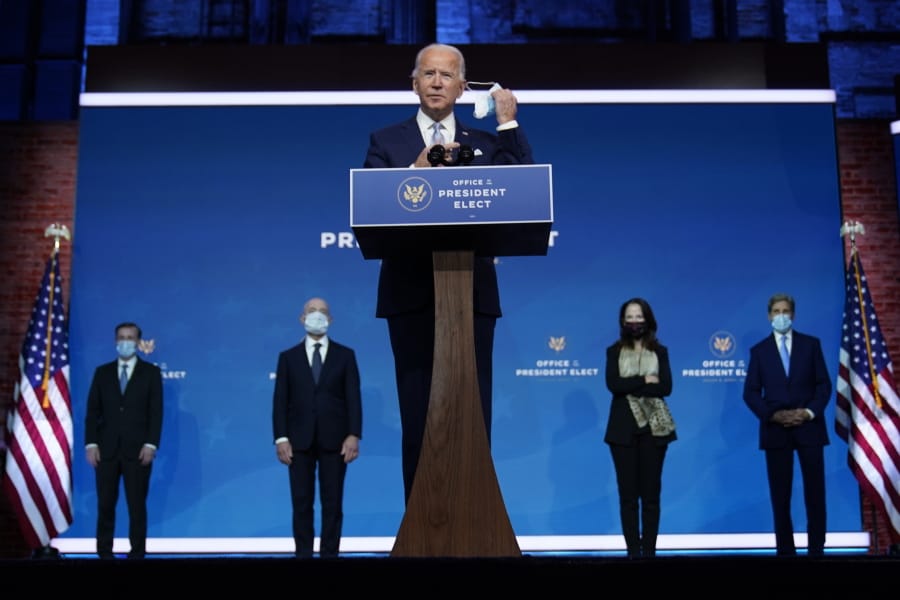 President-elect Joe Biden removes his face mask as he arrives to introduce his nominees and appointees to key national security and foreign policy posts at The Queen theater, Tuesday, Nov. 24, 2020, in Wilmington, Del.