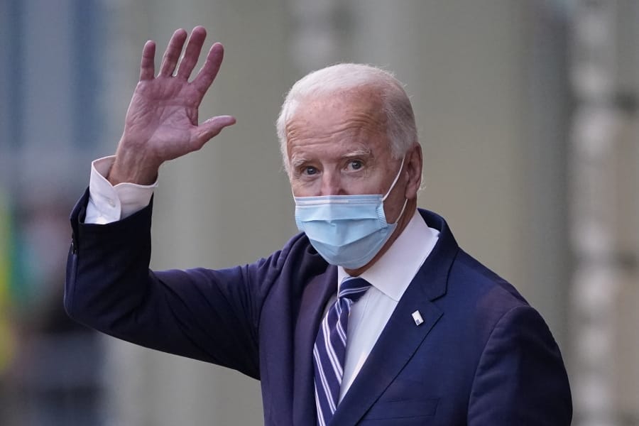President-elect Joe Biden wavs as he leaves The Queen theater, Tuesday, Nov. 10, 2020, in Wilmington, Del.