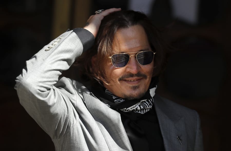 FILE - In this file photo dated Tuesday, July 28, 2020, US Actor Johnny Depp arrives at the High Court in London during his case against News Group Newspapers over a story published about his former wife Amber Heard, which branded him a &#039;wife beater&#039;.  A British judge is set to deliver his judgement in writing on Monday Nov.