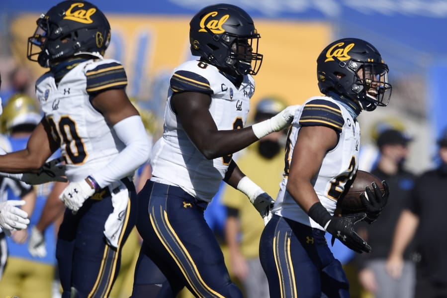 California cornerback Camryn Bynum, right, celebrates after intercepting a pass during the first half of an NCAA college football game against UCLA in Los Angeles, Sunday, Nov. 15, 2020.