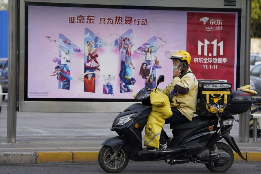 A delivery man passes by an ad for the Nov. 11 Sales Day in Beijing, China on Oct. 28, 2020. Chinese consumers are expected to spend tens of billions on everything from fresh food to luxury goods during this year&#039;s Singles&#039; Day online shopping festival, as the country recovers from the coronavirus pandemic.