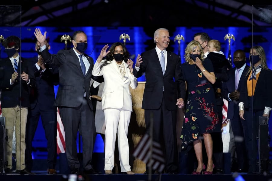 From left, Doug Emhoff, husband of Vice President-elect Kamala Harris, Harris, President-elect Joe Biden and Jill Biden, on stage together, Saturday, Nov.