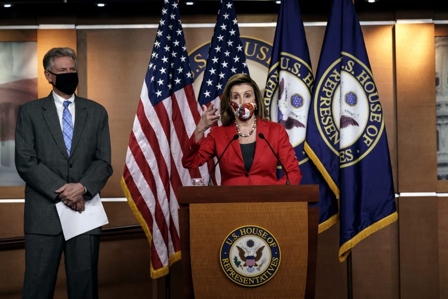 Speaker of the House Nancy Pelosi, D-Calif., talks to reporters about the impact of the election on the political landscape in Congress, at the Capitol in Washington, Friday, Nov. 6, 2020. She is joined at left by House Energy and Commerce Chairman Frank Pallone, D-N.J. (AP Photo/J.