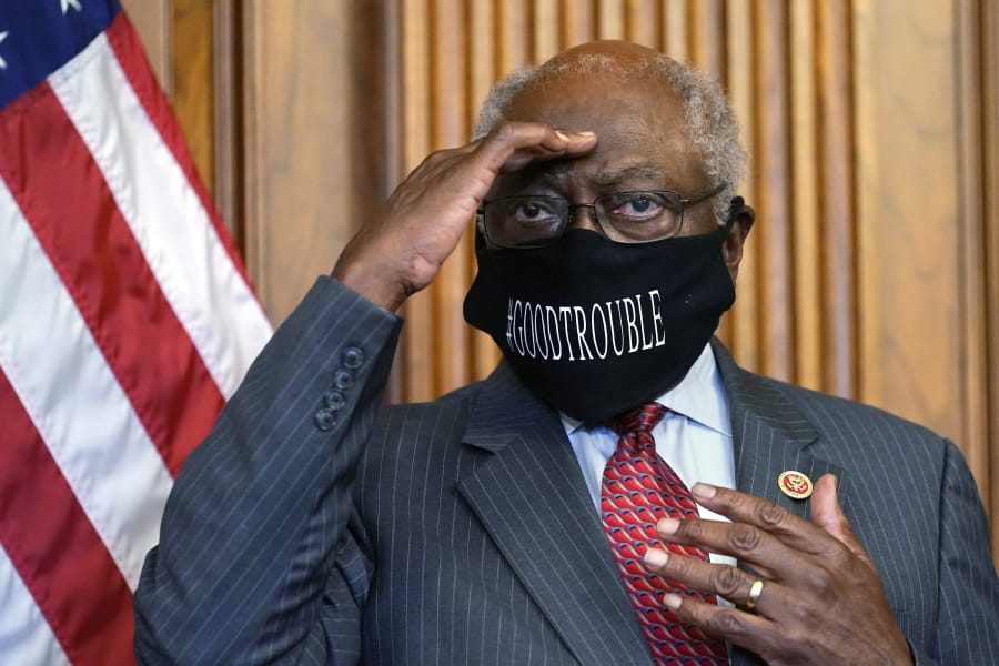 FILE - In this Sept. 17, 2020, file photo, House Majority Whip James Clyburn of South Carolina shields his eyes from a television light to look at a reporter asking a question during a news conference with House Speaker Nancy Pelosi on Capitol Hill. Clyburn and other Democrats blamed rhetoric about defunding local police departments for the party&#039;s surprise loss of seats in the House.