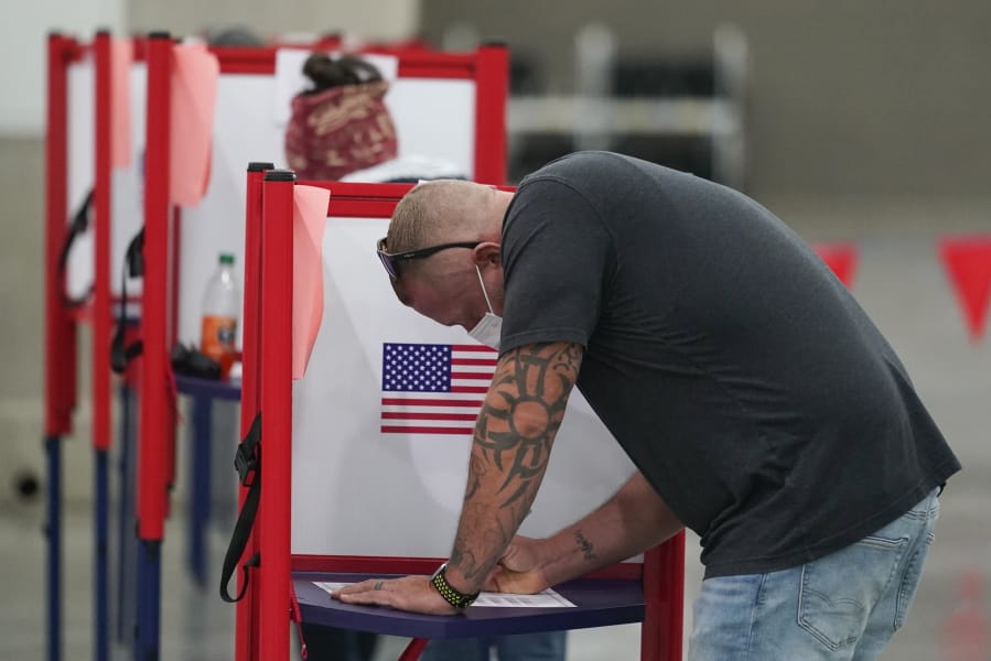 A voter marks his ballot at the Kentucky Exposition Center, on Election Day, Tuesday, Nov. 3, 2020, in Louisville, Ky.
