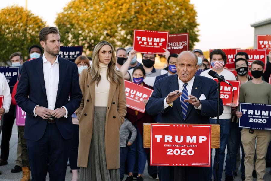 Rudy Giuliani, a lawyer for President Donald Trump, speaks during a news conference on legal challenges to vote counting in Pennsylvania, Wednesday, Nov. 4, 2020, in Philadelphia. At left are Eric Trump, son of President Trump, and his wife Lara Trump.