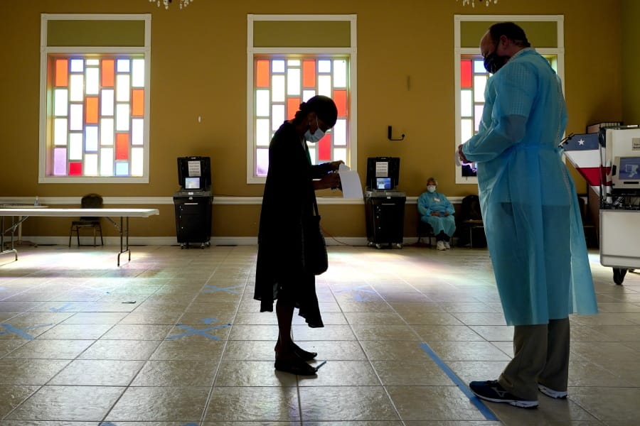 A woman waits to vote at the Cathedral of Praise church on Election Day Tuesday, Nov. 3, 2020, in Nashville, Tenn.