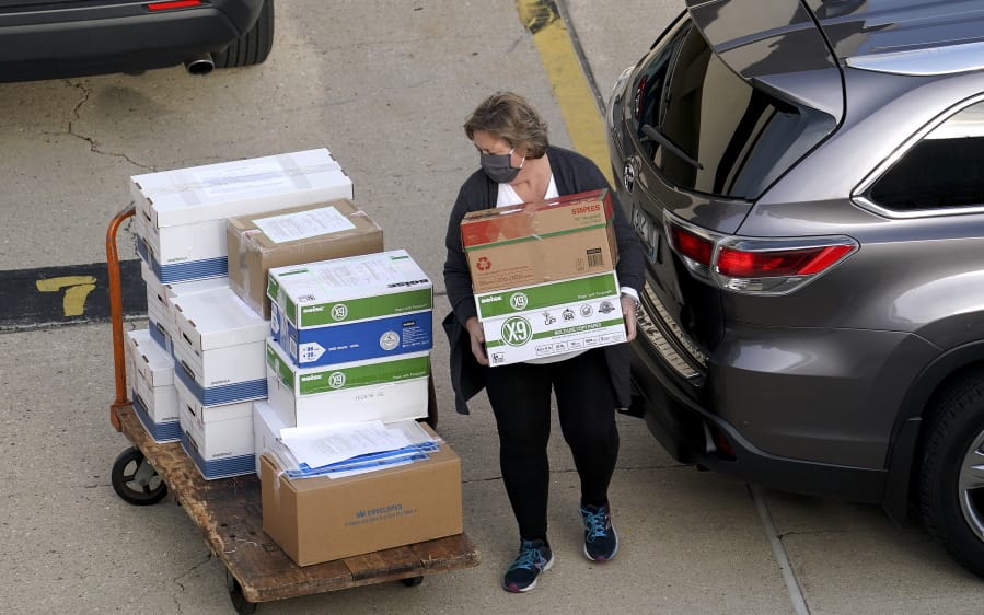 Election officials from around Dane County bring ballots in, Thursday, Nov., 19, 2020 to the Monona Terrace in Madison, Wis. for the recount that begins Friday.