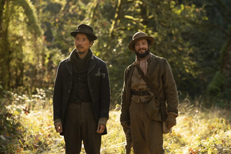 This image released by A24 shows Orion Lee, left, and and John Magaro in a scene from &quot;First Cow.&quot; Kelly Reichardt&#039;s film led all films in nominations for the 30th annual Gotham Awards with four nods, including best film, best screenplay, best actor for Magaro and breakthrough actor for Lee.