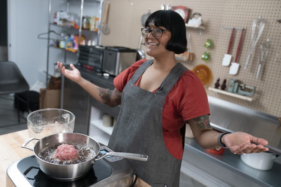 In this Oct. 7, 2020 photo, chef Sohla El-Waylly prepares Swedish meatballs during a taping of &quot;Stump Sohla,&quot; in New York. El-Waylly became a familiar face on YouTube as a standout on Bon Appetit&#039;s test kitchen channel. But during the nationwide racial reckoning following the police killing of George Floyd, she was among members of the test kitchen who accused the channel&#039;s owner, Conde Nast, of discriminatory practices. She departed Bon Appetit in August after failed negotiations. Her new show is her own, pushing her to deploy her talent, charm and encyclopedic culinary chops to solve challenges.