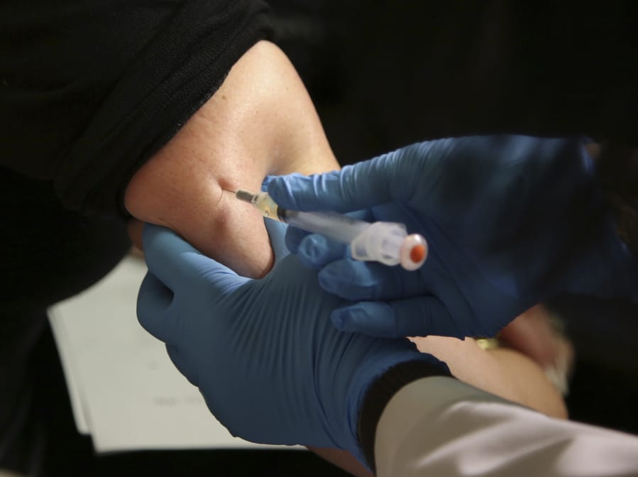 FILE - In this March 27, 2019 file photo, a woman receives a measles, mumps and rubella vaccine at the Rockland County Health Department in Pomona, N.Y., north of New York City. The number of children sickened by measles in 2019 hit the highest caseload in 23 years, according to new data published by the World Health Organization and the U.S. Centers for Disease Control and Prevention. In a study published on Thursday, Nov. 12, 2020, WHO and CDC said were nearly 870,000 cases of measles last year and that the number of deaths - about 207,500 - increased by almost 50% since 2016.