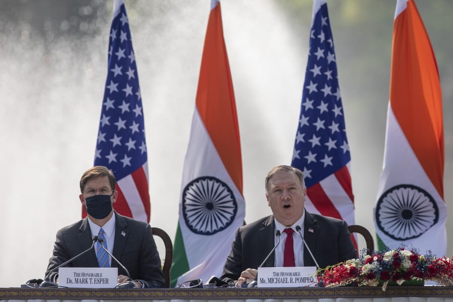 U.S. Secretary of State Mike Pompeo, right, speaks with Secretary of Defence Mark Esper seated beside him during a joint press conference with their Indian counterparts at Hyderabad House in New Delhi, India, Tuesday, Oct. 27, 2020. With President Donald Trump in a tight race for a second term against former Vice President Joe Biden, Pompeo and Esper sought to play on Indian suspicions about China to shore up a regional front against increasing Chinese assertiveness in the Indo-Pacific region.