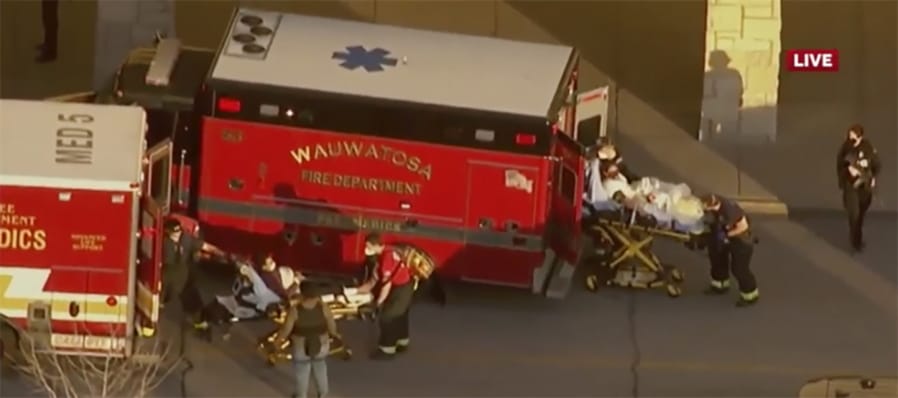 In this image taken from video provided by WISN-TV, emergency crews place two people in waiting ambulances at the Mayfair Mall in Wauwatosa, Wis., on Friday, Nov. 20, 2020. A police dispatcher says officers are responding to &quot;a very active situation&quot; at the suburban Milwaukee mall.