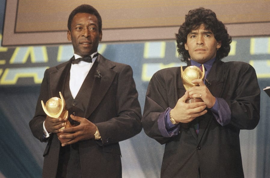 FILE - In this March 1987 file photo, Pele, left, and Maradona hold &quot;Sports Oscar&quot; trophies in Milan, Rome. The Argentine soccer great who was among the best players ever and who led his country to the 1986 World Cup title before later struggling with cocaine use and obesity, died from a heart attack on Wednesday, Nov. 25, 2020, at his home in Buenos Aires. He was 60.
