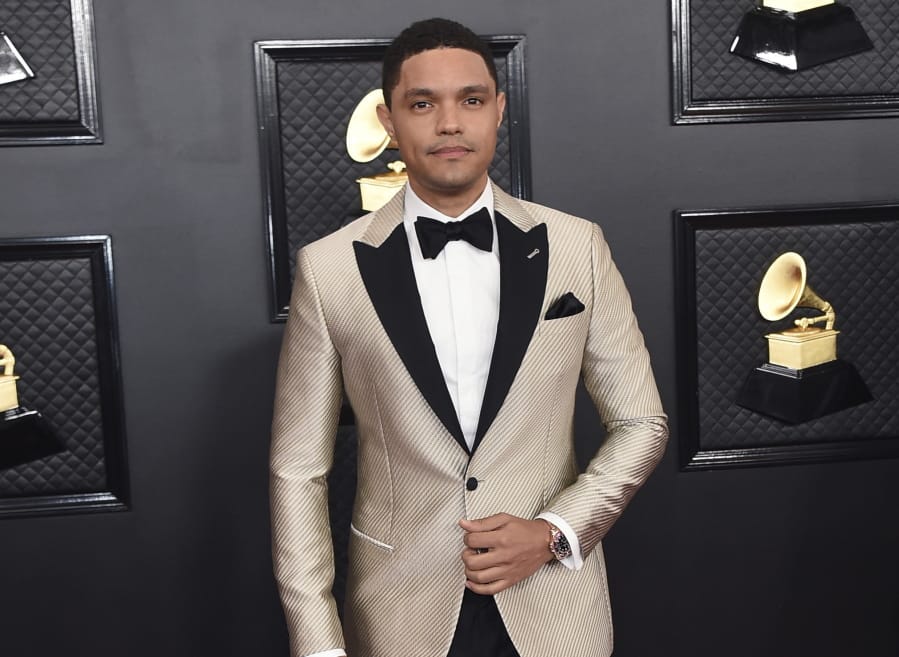 FILE - Trevor Noah arrives at the 62nd annual Grammy Awards in Los Angeles on Jan. 26, 2020. Noah has been tapped to host the 2021 Grammy Awards. The Recording Academy made the announcement hours before the nominees for the 2021 show would be revealed. It would mark Noah&#039;s first time hosting the Grammys.