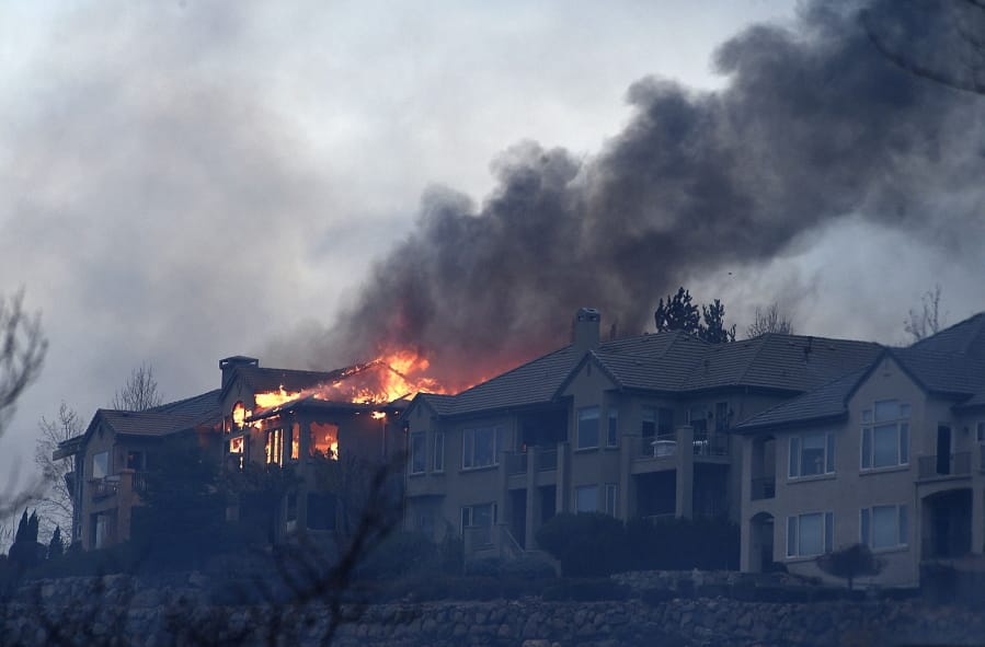 A large home burns during the Pinehaven Fire in the Caughlin Ranch area of Reno, Nev., on Tuesday, Nov. 17, 2020.