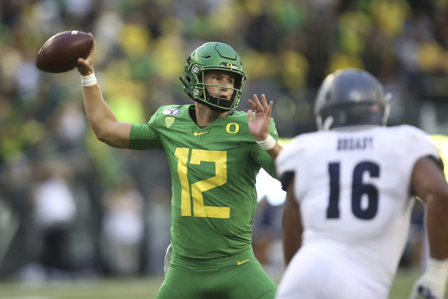 Oregon quarterback Tyler Shough, left, is a new starter along with five new offensive linemen. Expected to finish atop the Pac-12, the Ducks open at home with Stanford and will face Oregon State during the Thanksgiving weekend.